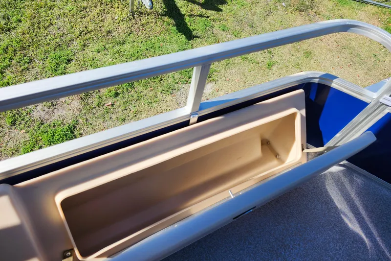 Slide: The Image of 2018 Sun Tracker Fishin' Barge 22 DLX storage compartment with railing, viewed from above. - 18