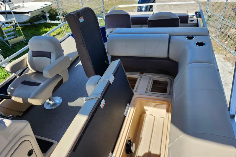 Slide: The Image of 2018 Sun Tracker Fishin' Barge 22 DLX interior with seating and storage compartments. - 21