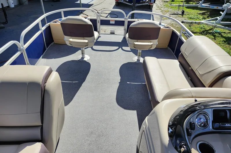 Slide: The Image of 2018 Sun Tracker Fishin' Barge 22 DLX interior with seating and steering console. - 24