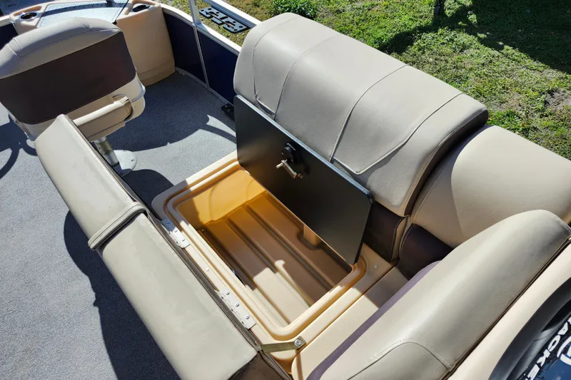 Slide: The Image of 2018 Sun Tracker Fishin' Barge 22 DLX with open storage compartment and seating. - 26