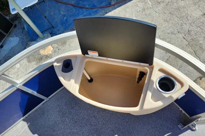 Slide: The Image of 2018 Sun Tracker Fishin' Barge 22 DLX boat console with cup holder and storage. - 28