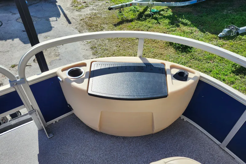 Slide: The Image of 2018 Sun Tracker Fishin' Barge 22 DLX deck with cup holders and measuring board. - 29