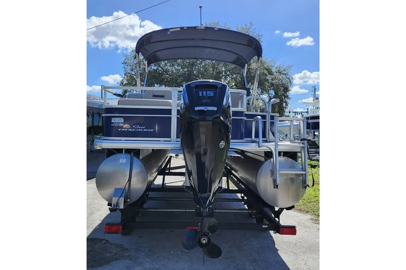 Slide: The Image of 2018 Sun Tracker Fishin' Barge 22 DLX pontoon boat with 115 HP motor, parked outdoors. - 5