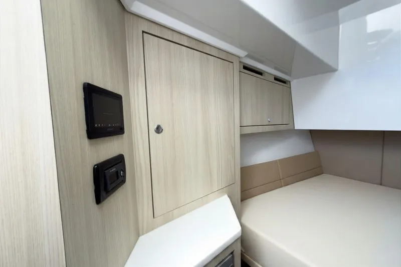 Slide: The Image of Interior of Intrepid 35 PANACEA 2026 with wood paneling and bed. - 16