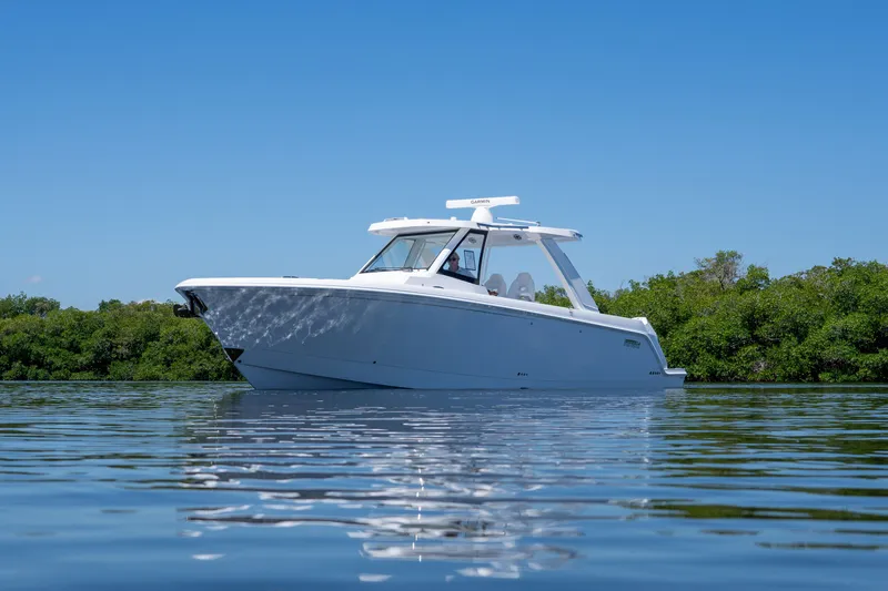Slide: The Image of Intrepid 35 PANACEA 2026 on calm water with green backdrop. - 2