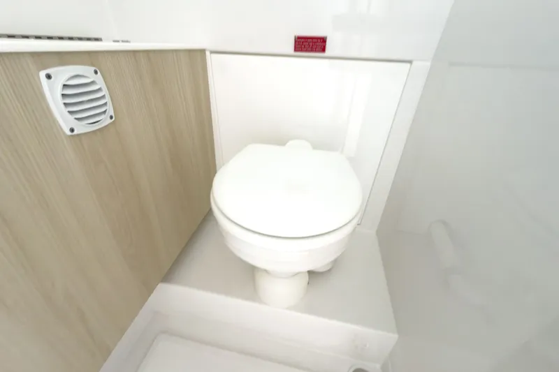 Slide: The Image of Intrepid 35 PANACEA 2026 boat toilet with wood paneling. - 21