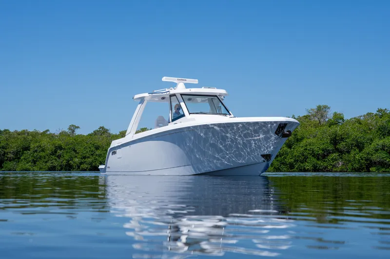 Slide: The Image of Intrepid 35 PANACEA 2026 on calm water with green backdrop. - 28