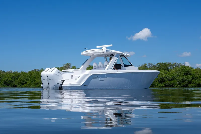 Slide: The Image of Intrepid 35 PANACEA 2026 on calm water with green backdrop. - 31