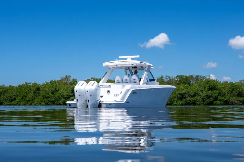 Slide: The Image of Intrepid 35 PANACEA 2026 on calm water with green backdrop. - 32