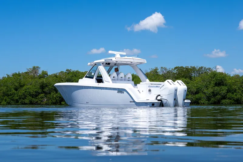Slide: The Image of Intrepid 35 PANACEA 2026 on calm water with green backdrop. - 34