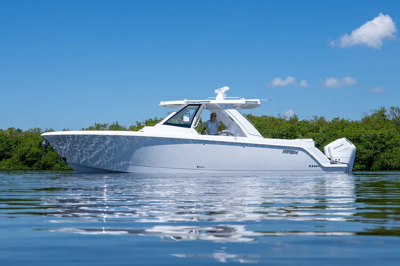 Slide: The Image of Intrepid 35 PANACEA 2026 on calm water under clear sky. - 35
