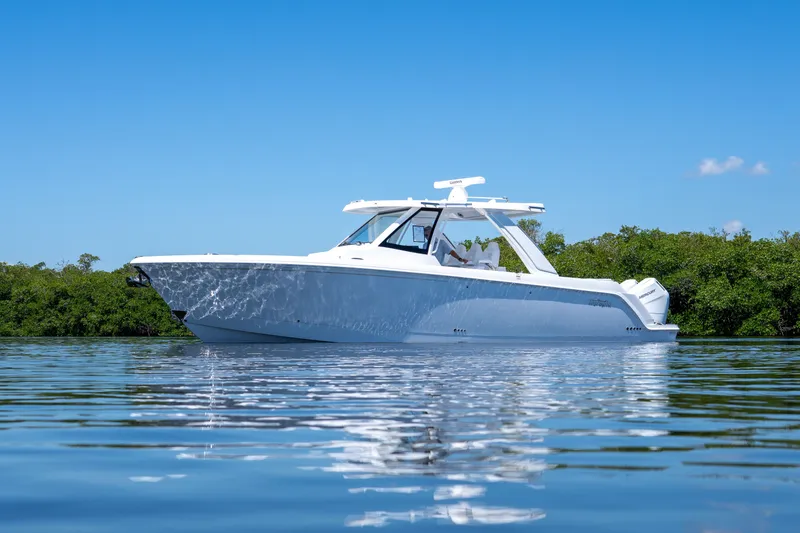 Slide: The Image of Intrepid 35 PANACEA 2026 on calm water with green backdrop. - 36