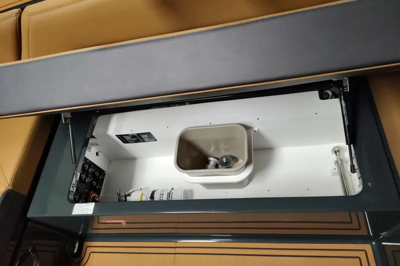 Slide: The Image of 2026 Cobalt R8 Surf boat storage compartment with organized interior components. - 10
