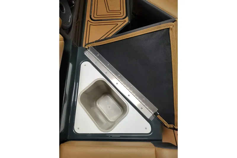 Slide: The Image of 2026 Cobalt R8 Surf boat interior with built-in storage compartment and tan upholstery. - 11