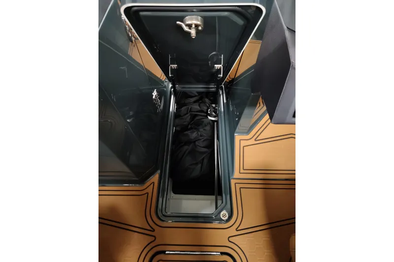 Slide: The Image of Open storage compartment in 2026 Cobalt R8 Surf boat, featuring sleek design and spacious interior. - 13