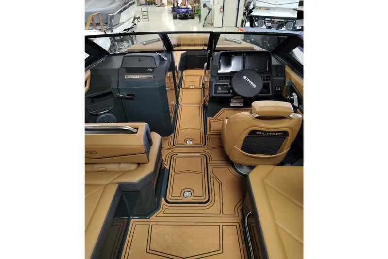 Slide: The Image of Luxurious interior of 2026 Cobalt R8 Surf boat with tan leather seating and modern dashboard. - 23