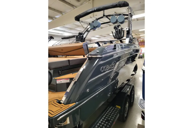 Slide: The Image of 2026 Cobalt R8 Surf boat in showroom, featuring sleek design and modern amenities. - 3