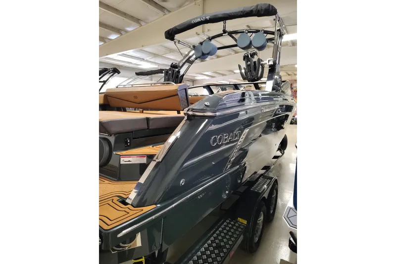 Slide: The Image of 2026 Cobalt R8 Surf boat with sleek design and modern features in showroom. - 4