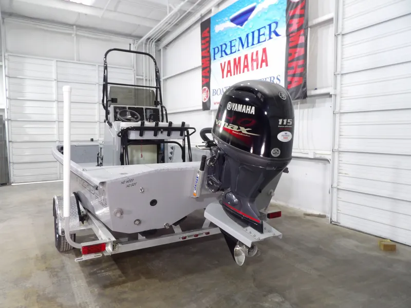 Slide: The Image of 2024 Freedom 18 PATRIOT CAT boat with Yamaha engine in a garage. - 6