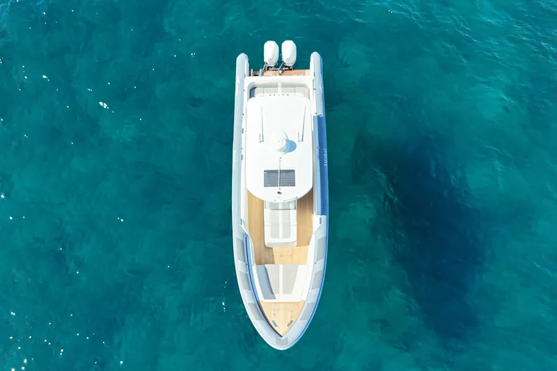Slide: The Image of Aerial view of 2022 Ocean 1 model 370 boat on clear blue water. - 2
