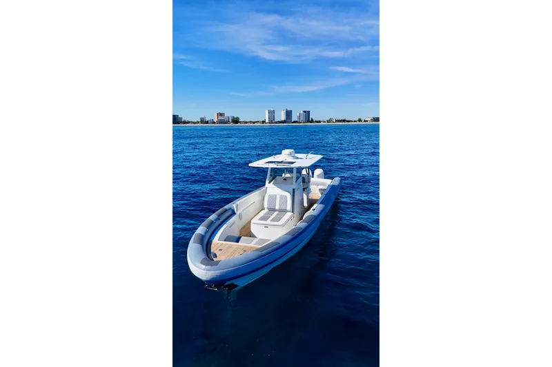 Slide: The Image of Ocean 1 370 boat on blue water, 2022 model, with city skyline in background. - 3