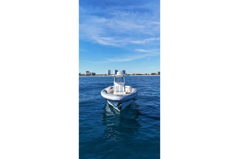 Slide: The Image of Ocean 1 370 boat on calm blue water, city skyline in background, 2022 model. - 9