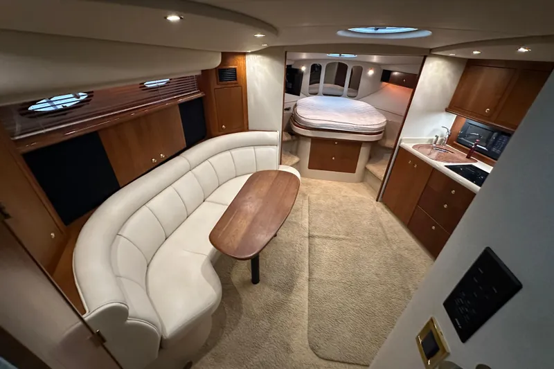 Slide: The Image of Interior of 1999 Cruisers Yachts 3870 Esprit with cozy seating and kitchenette. - 14