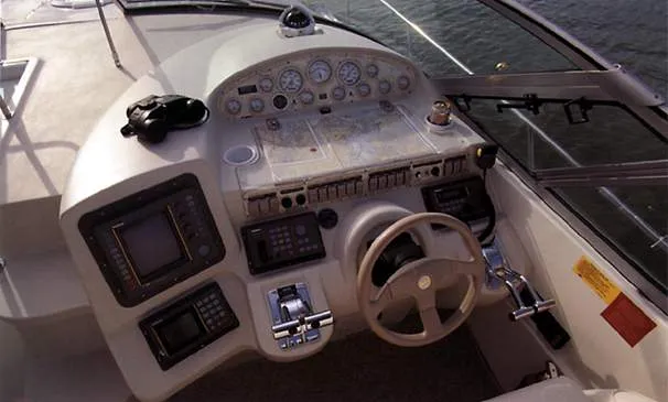 Slide: The Image of 1999 Cruisers Yachts 3870 Esprit docked indoors, surrounded by other boats. - 2