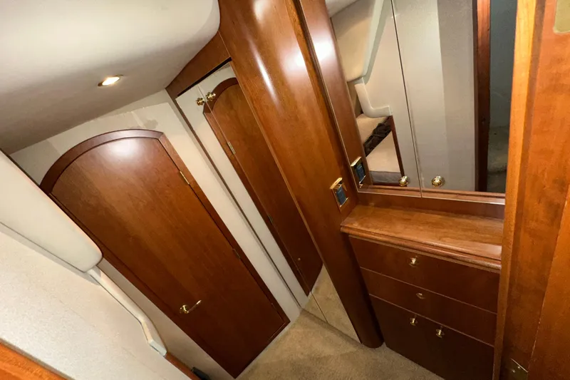 Slide: The Image of 1999 Cruisers Yachts 3870 Esprit interior with wooden cabinetry and mirrored dresser. - 22