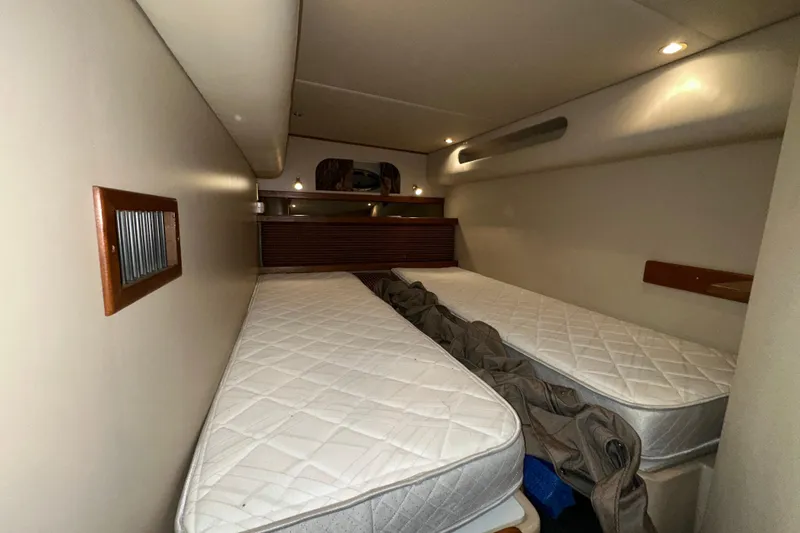 Slide: The Image of 1999 Cruisers Yachts 3870 Esprit cabin with twin beds and cozy lighting. - 23
