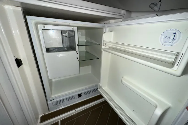 Slide: The Image of 1999 Cruisers Yachts 3870 Esprit refrigerator interior with warranty sticker. - 8