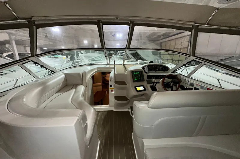 Slide: The Image of 1999 Cruisers Yachts 3870 Esprit cockpit with modern controls and spacious seating. - 9