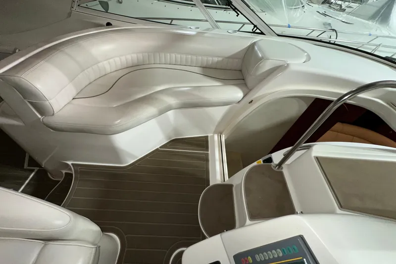 Slide: The Image of 1999 Cruisers Yachts 3870 Esprit interior with white seating and control panel. - 12