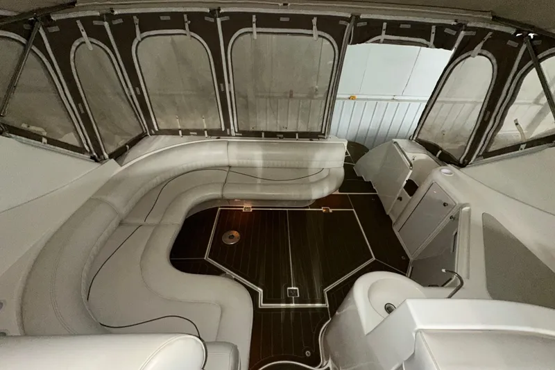 Slide: The Image of 1999 Cruisers Yachts 3870 Esprit interior with white seating and dark wood flooring. - 13