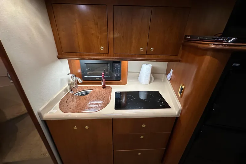 Slide: The Image of 1999 Cruisers Yachts 3870 Esprit galley with sink, stove, and microwave. - 16