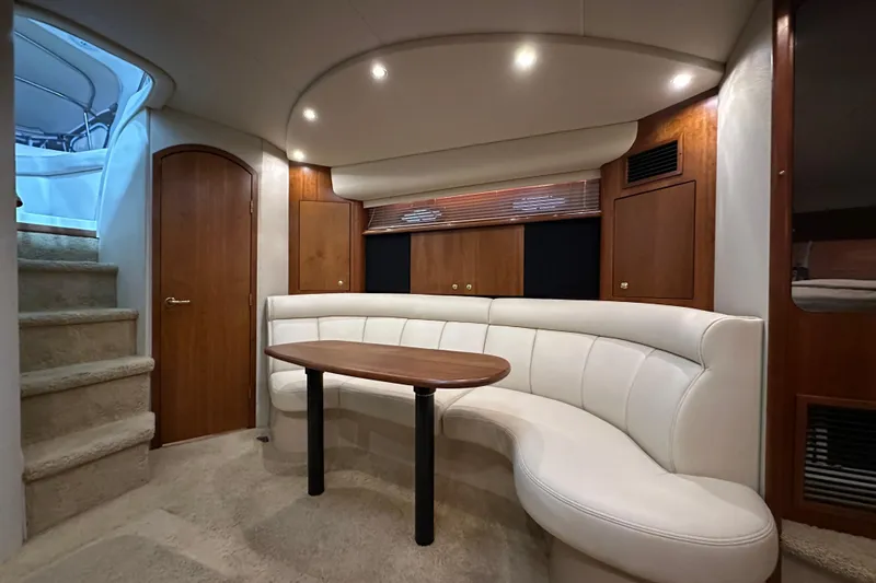 Slide: The Image of Luxurious interior of 1999 Cruisers Yachts 3870 Esprit with curved seating and wooden accents. - 17