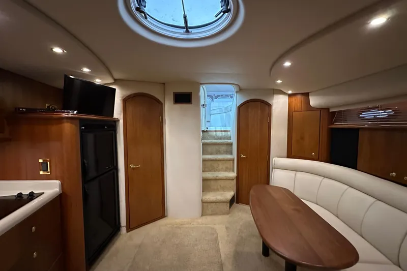 Slide: The Image of 1999 Cruisers Yachts 3870 Esprit interior with cozy seating, wooden accents, and modern amenities. - 19