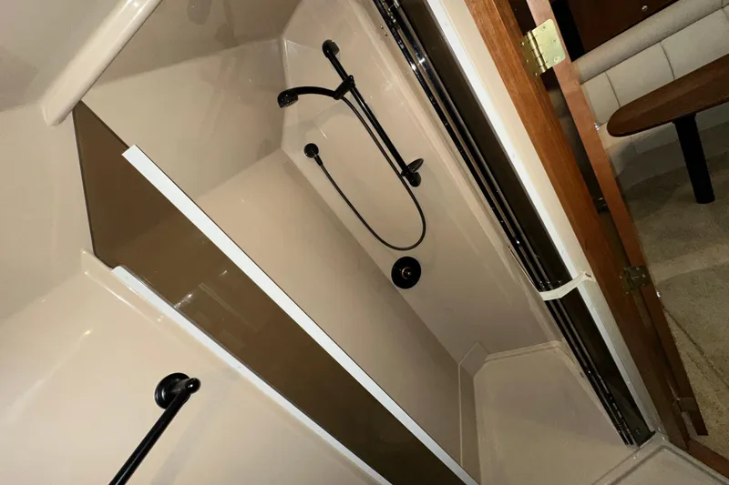 Slide: The Image of 1999 Cruisers Yachts 3870 Esprit bathroom with shower and wooden door. - 21