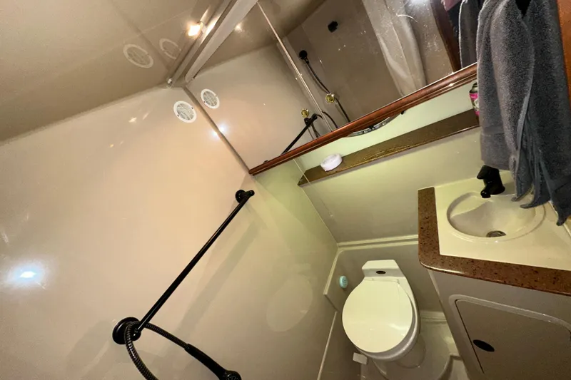 Slide: The Image of 1999 Cruisers Yachts 3870 Esprit bathroom with sink, toilet, and shower. - 24