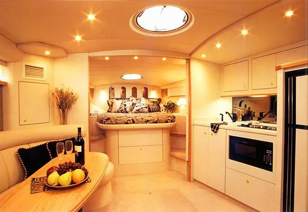 Slide: The Image of 1999 Cruisers Yachts 3870 Esprit in storage, featuring covered cockpit and sleek design. - 4