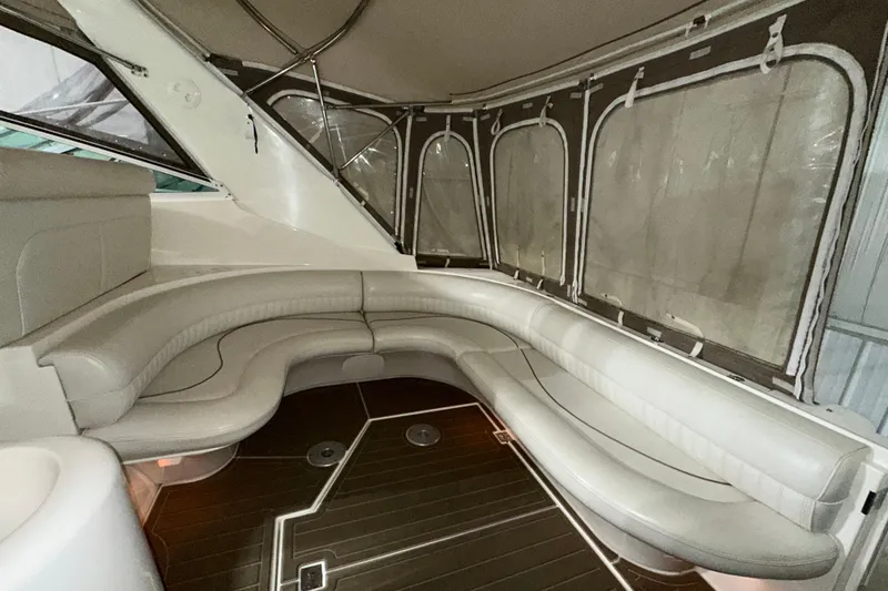 Slide: The Image of 1999 Cruisers Yachts 3870 Esprit interior with curved seating and wood flooring. - 6