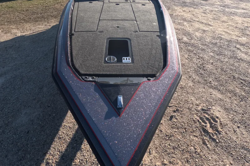 Slide: The Image of 2026 Bullet 21XST boat deck with carpeted surface and storage compartment. - 3