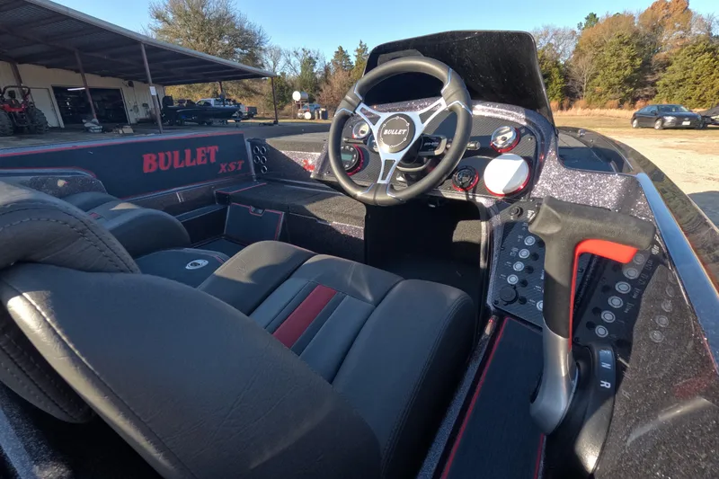 Slide: The Image of Interior of a 2026 Bullet 21XST boat, featuring a sleek steering wheel and modern dashboard. - 4