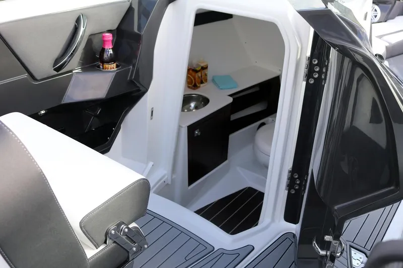 Slide: The Image of Manufacturer Provided Image: Interior of 2021 Monterey 305SS Super Sport boat with compact cabin amenities. - 13
