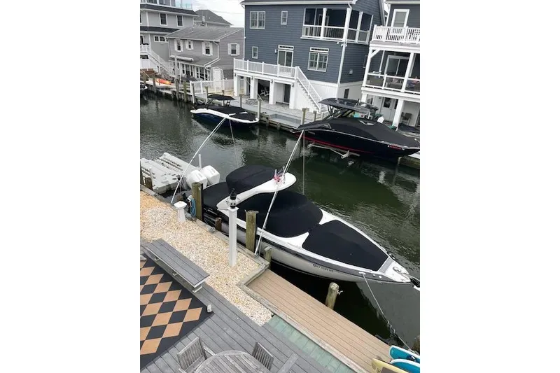 Slide: The Image of 2021 Monterey 305SS Super Sport docked by waterfront homes. - 4