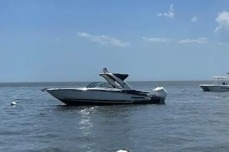 Slide: The Image of 2021 Monterey 305SS Super Sport boat on calm water. - 5