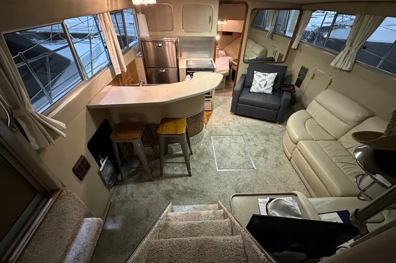 Slide: The Image of Luxurious interior of 1986 Chris-Craft 381 Catalina yacht with modern furnishings and kitchen. - 10