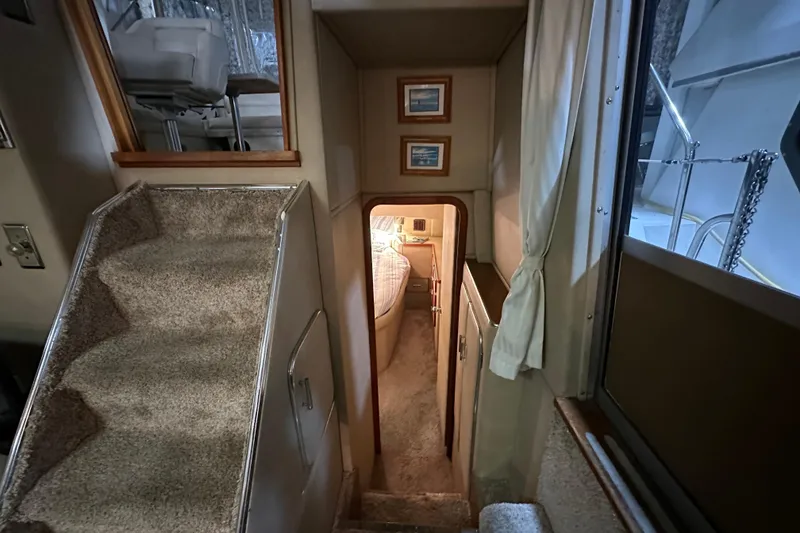 Slide: The Image of Interior of 1986 Chris-Craft 381 Catalina yacht, featuring carpeted stairs and cozy cabin entrance. - 15