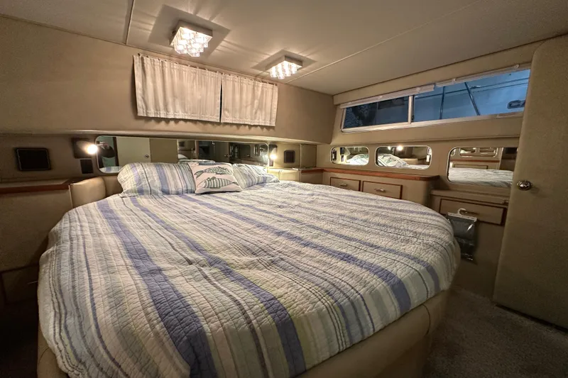Slide: The Image of Luxurious bedroom interior of 1986 Chris-Craft 381 Catalina yacht with cozy bedding. - 17