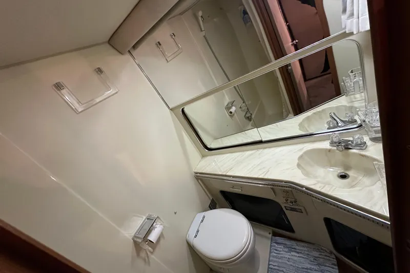Slide: The Image of 1986 Chris-Craft 381 Catalina bathroom with sink, mirror, and toilet. - 18